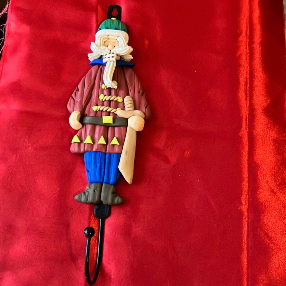 Clay man figure on metal hook red blue green white yellow brown tan